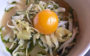 Squid and cabbage topped with a buttery-textured egg yolk swimming in a toasted yeast chicken broth.