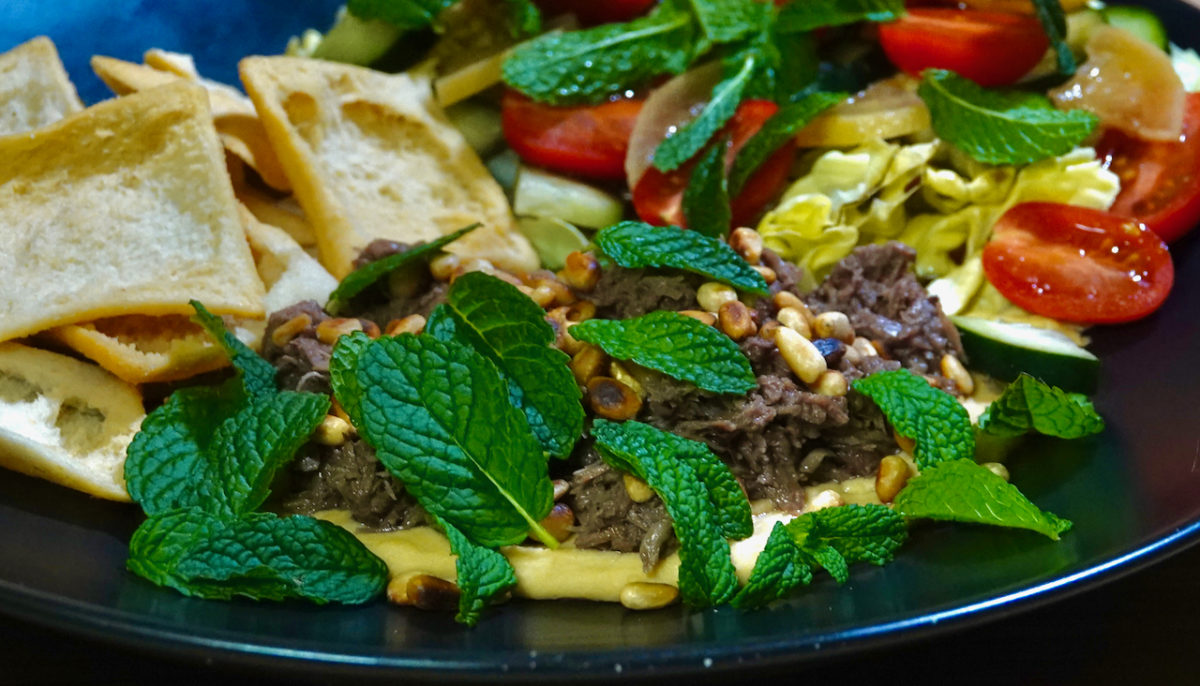 Mar 12: Warm Shredded Lamb on Hummus with Pita Chips, and a Lettuce, Cucumber, Preserved Lemon and Mint Salad