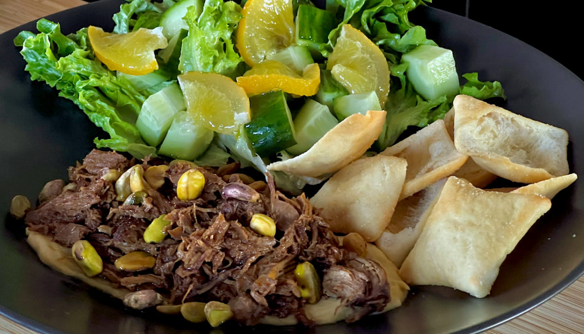 Jul 24: Warm Shredded Lamb on Hummus with Pita and a Lettuce, Cucumber, Pistachio and Preserved Lemon Salad